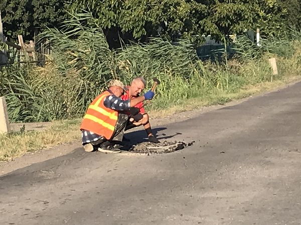 Вторая жизнь асфальта: в Килии коммунальщики засыпают ямы на дорогах асфальтной крошкой